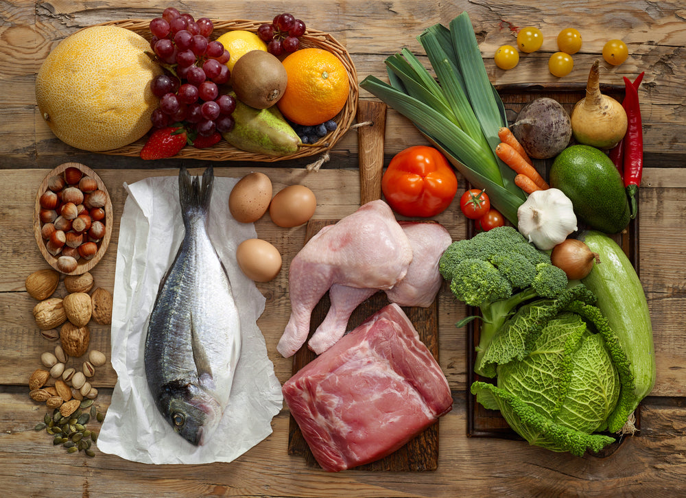 A variety of health foods including fruits, vegetables, meat and fish. Superfoods.