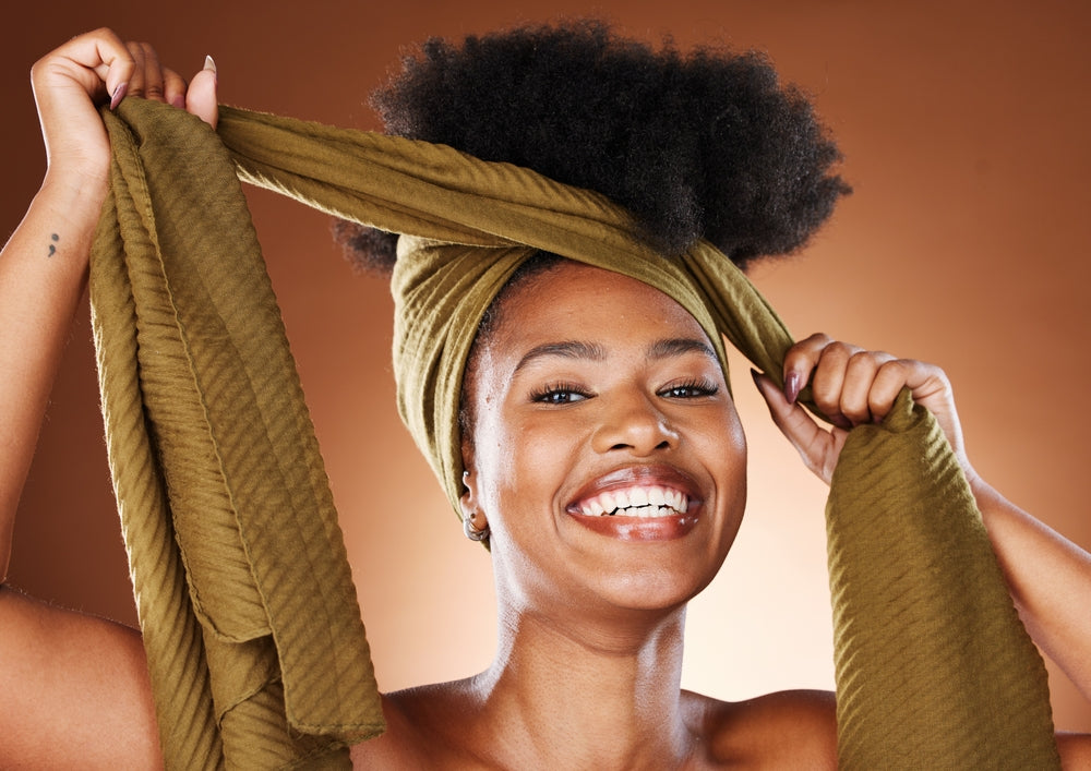 Woman with afro hair wrap for protection and style.