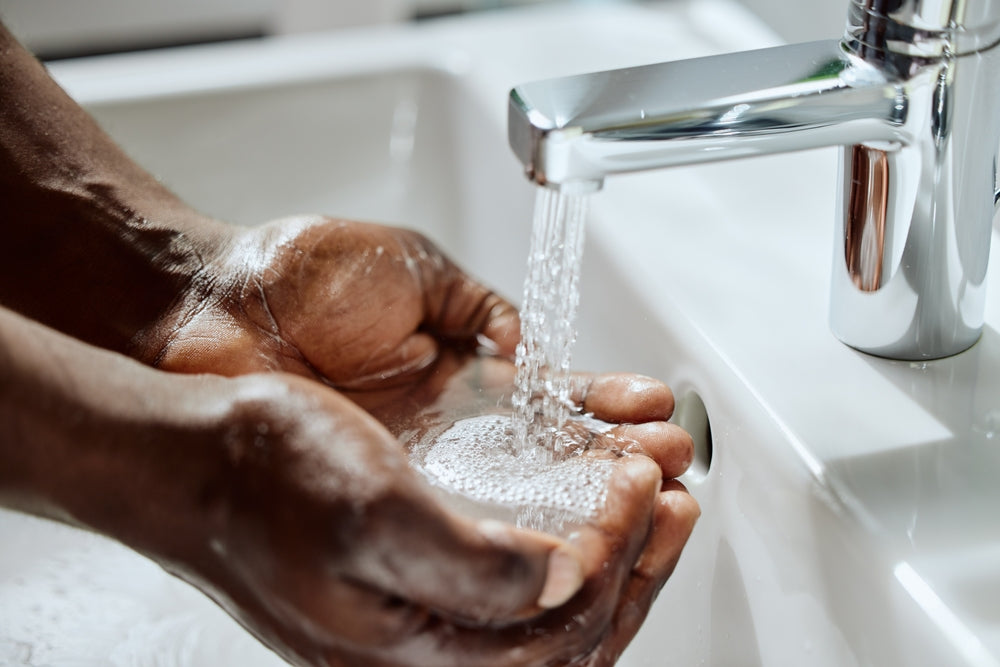 Tap water and man washing hands.